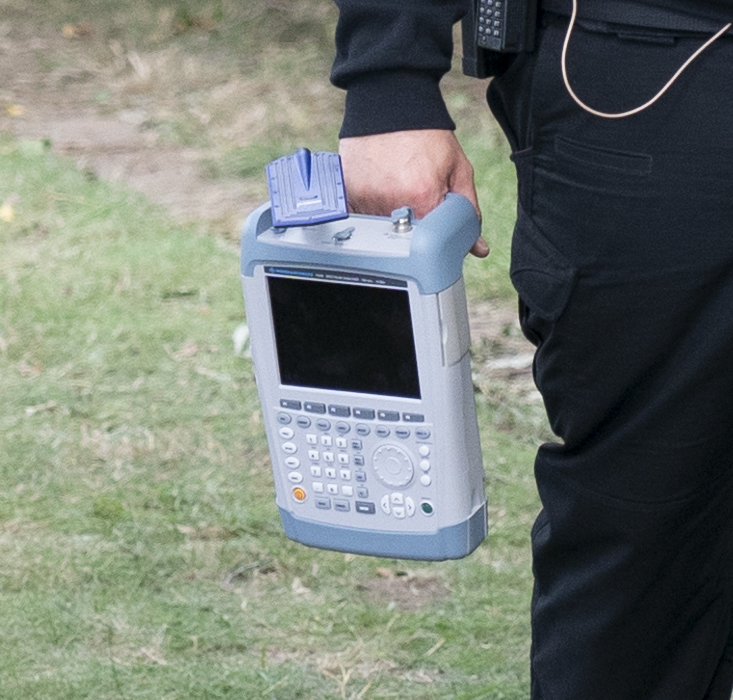 A German cop carrying specialist ground radar equipment