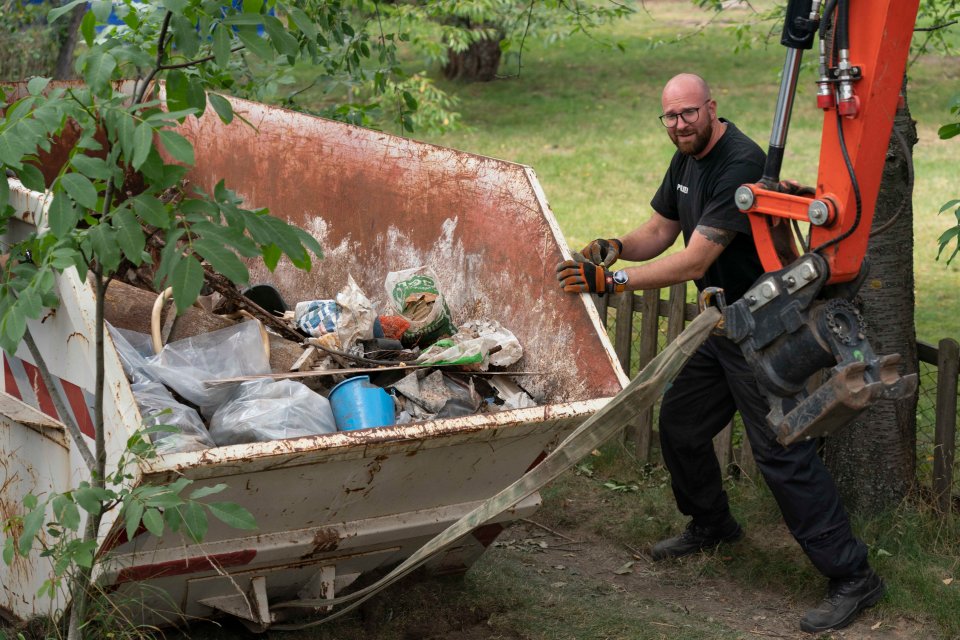 An officer looks on as the skip is hauled away