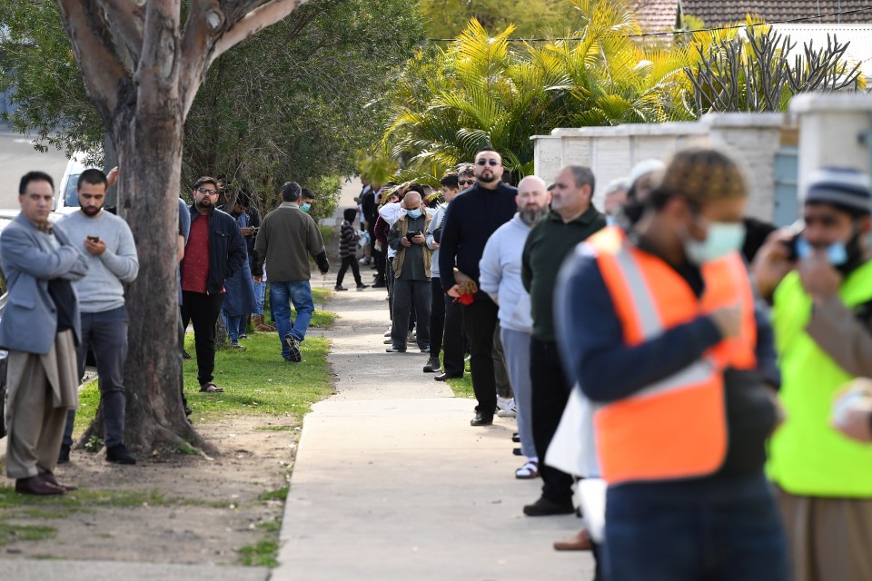 Muslim worshippers wait in a queue to enter the Auburn Gallipoli Mosque for a mass Friday prayer on the first day of the Eid al-Adha