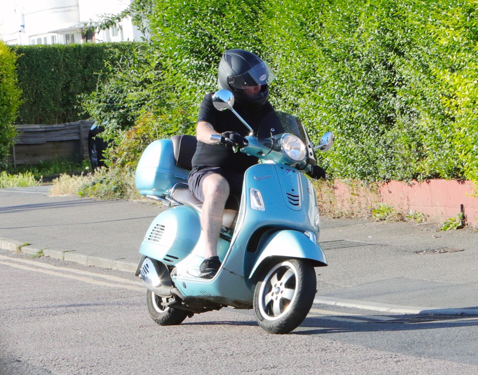 The actor sped along the road in his helmet, a tight top and shorts