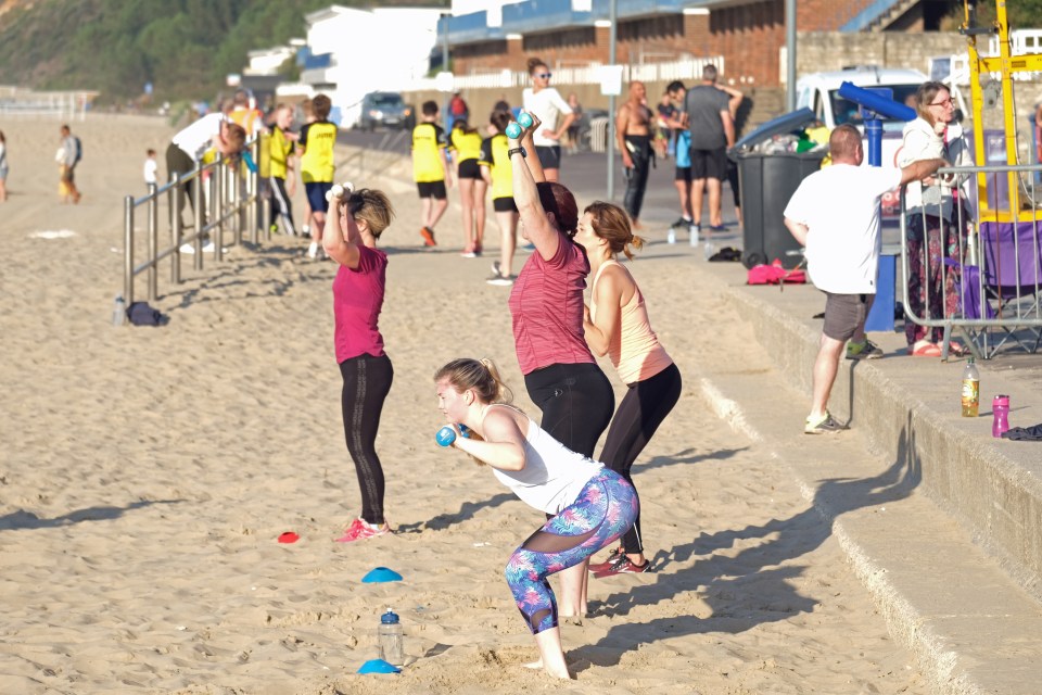 Fitness fanatics worked out in the sands, despite the high temps