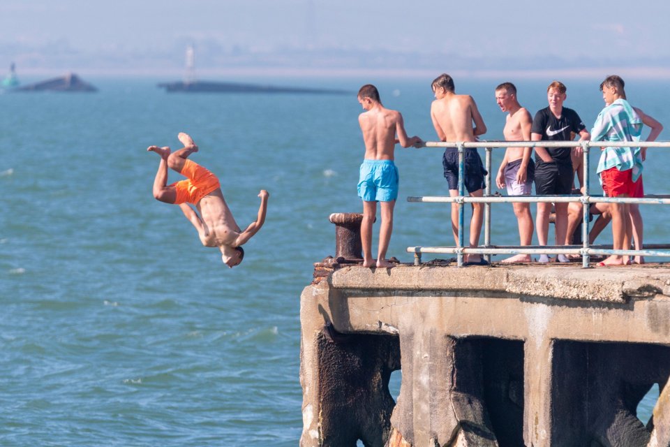 A group of daredevils jumping off Southend pier