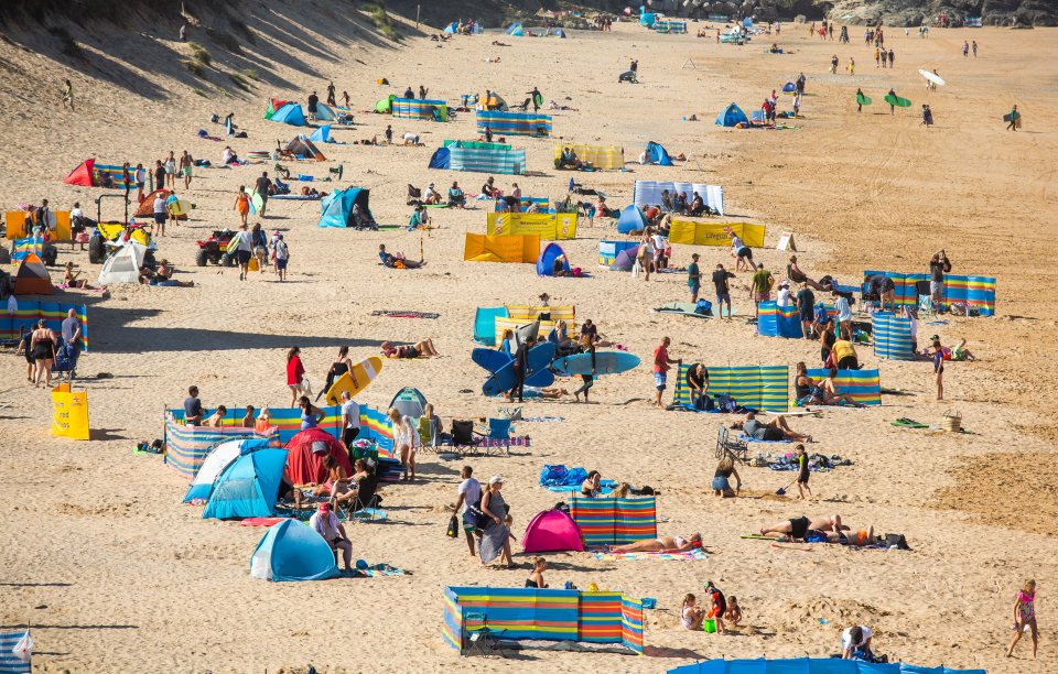 Sands at Lyme Regis, Dorset are already covered with windbreaks ready for a day at the beach