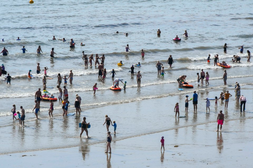 Paddlers in Lyme Regis, Dorset