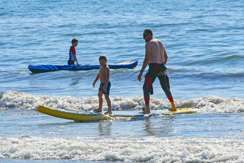 A pair of paddle boarders get to grips with the waves