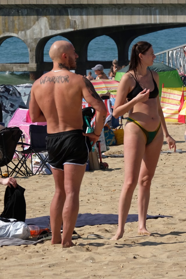 A woman in a black bikini enjoying the sun in Bournemouth