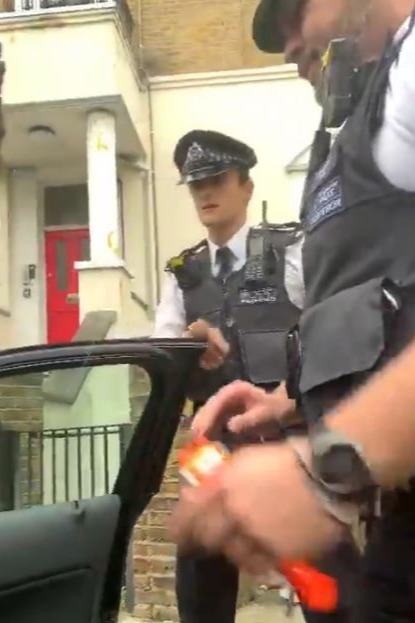 Police officers stop a car in West London and detain a couple while searching for ‘weapons’