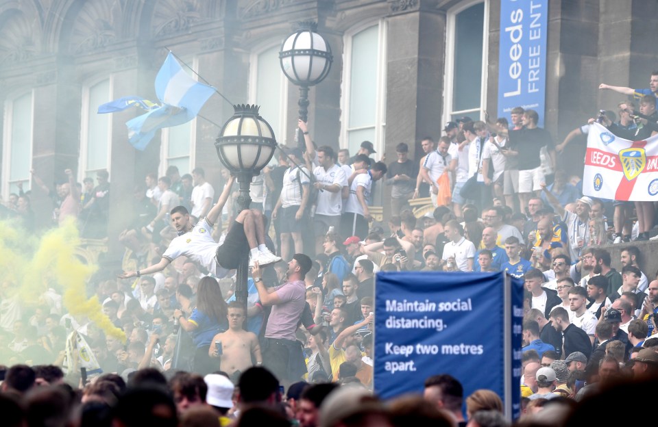 Leeds United fans celebrate winning The Championship title in Millennium Square for a third day