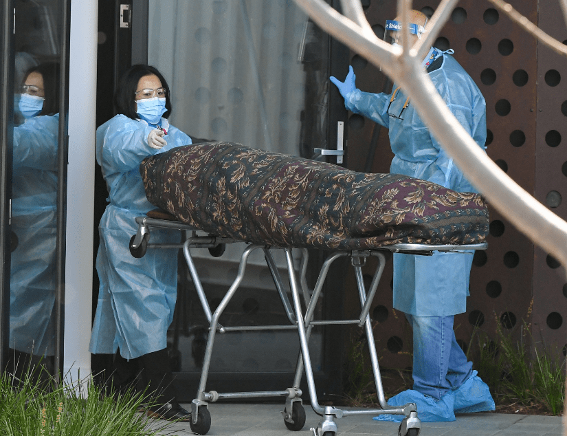 The body of a resident is taken away from the Epping Gardens aged care facility in Melbourne