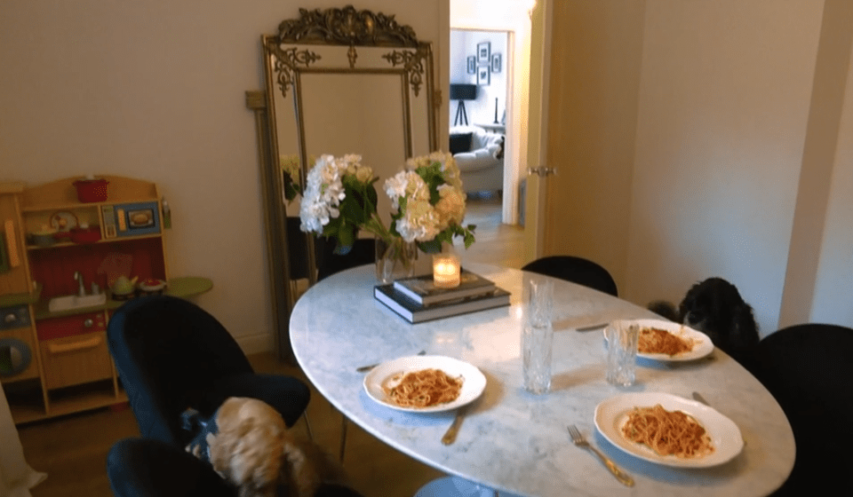  The dining area has an ornate antique-look mirror