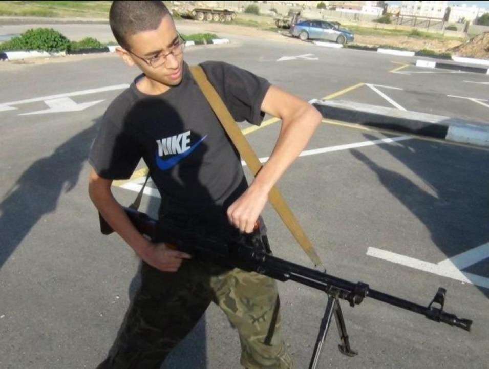 Hashem poses with a machine gun in a Facebook post