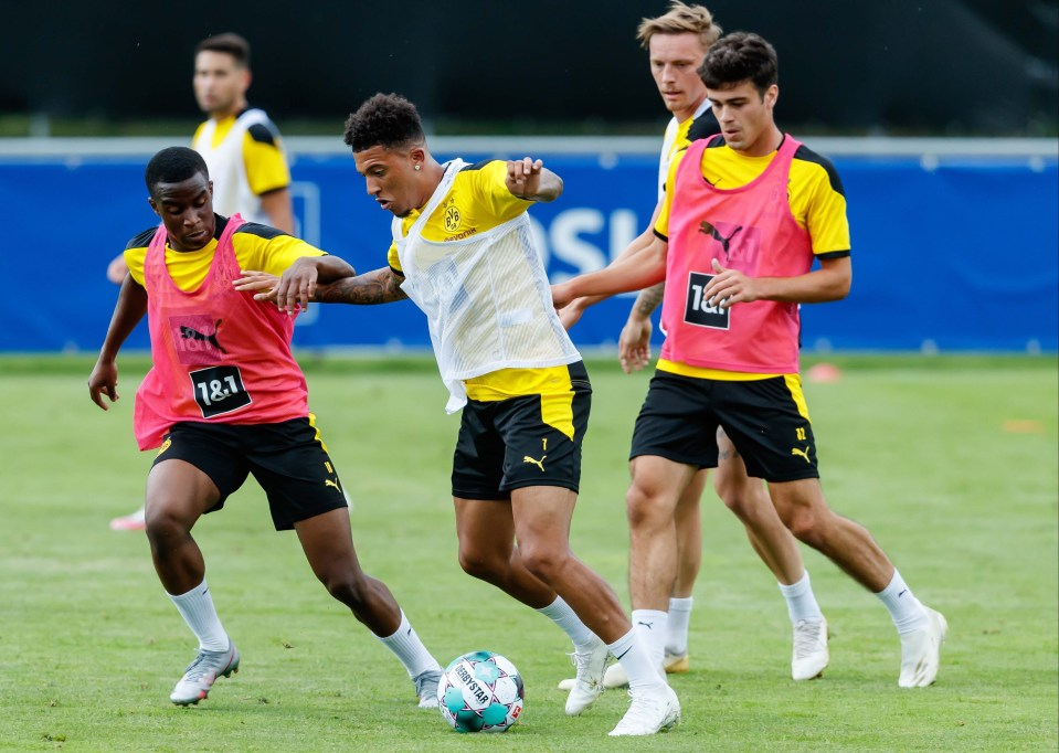 Moukoko, left, battles with Jadon Sancho in training