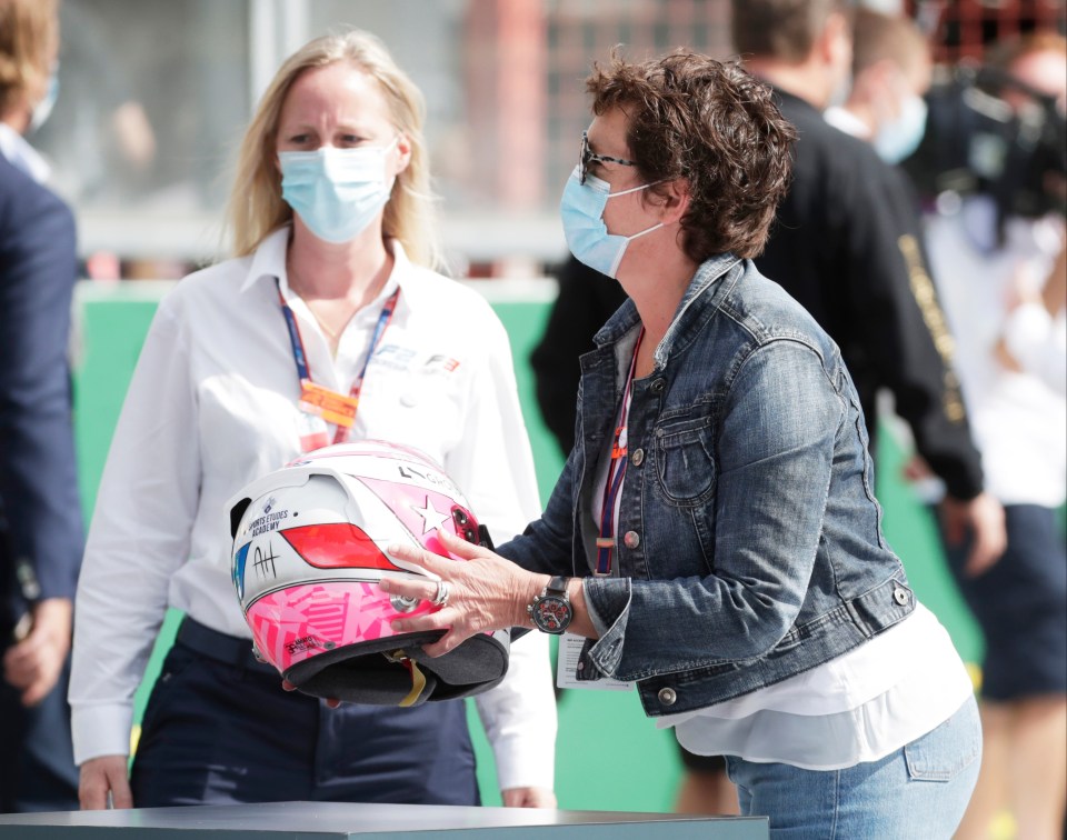 Anthoine Hubert's mum Nathalie collects her son's helmet