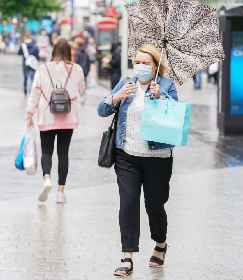 Winds could reach up to 50mph, and this woman was struggling with her brolly in Liverpool city centre