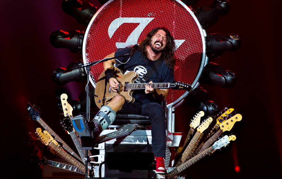 Foo Fighters rocker Dave Grohl on stage sitting on a special throne due to his broken leg, at Ziggodome, Amsterdam, Netherlands, 05 November 2015