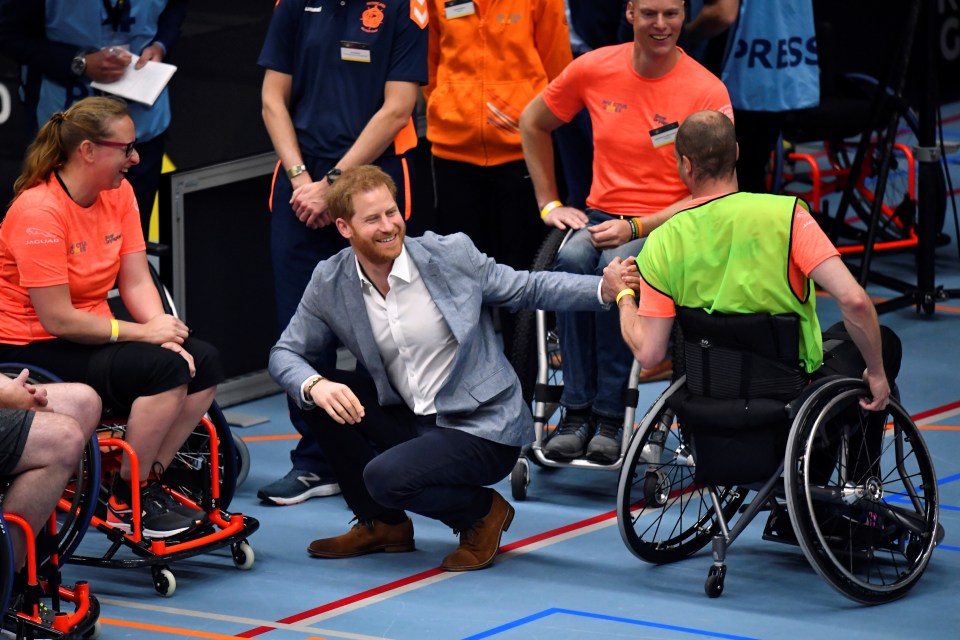 Prince Harry talks with athletes during the official launch of the one year countdown to the Invictus Games 