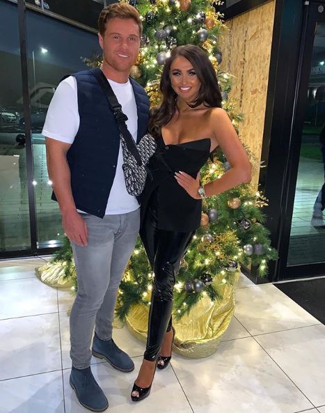 The couple posing for a picture together at Christmas