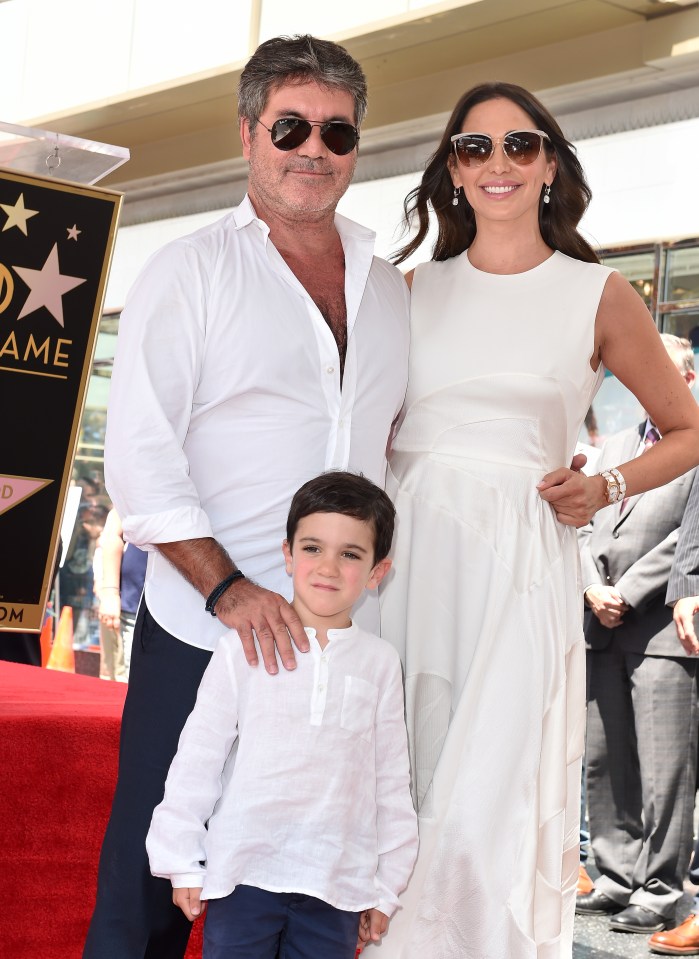 Simon pictured with girlfriend Lauren and son Eric 