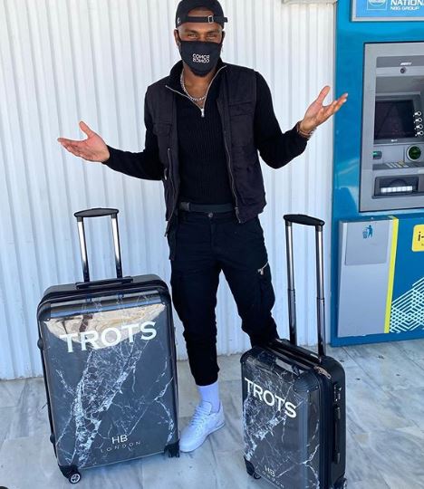 Luke posed at the airport with his personalised luggage