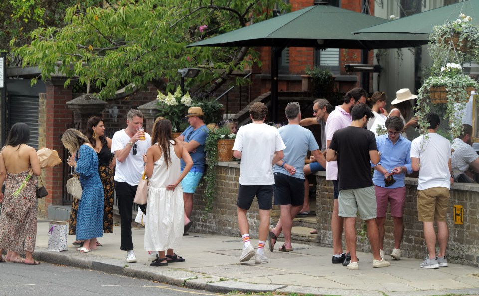 Brits gather outside a bar on Portobello Road, London