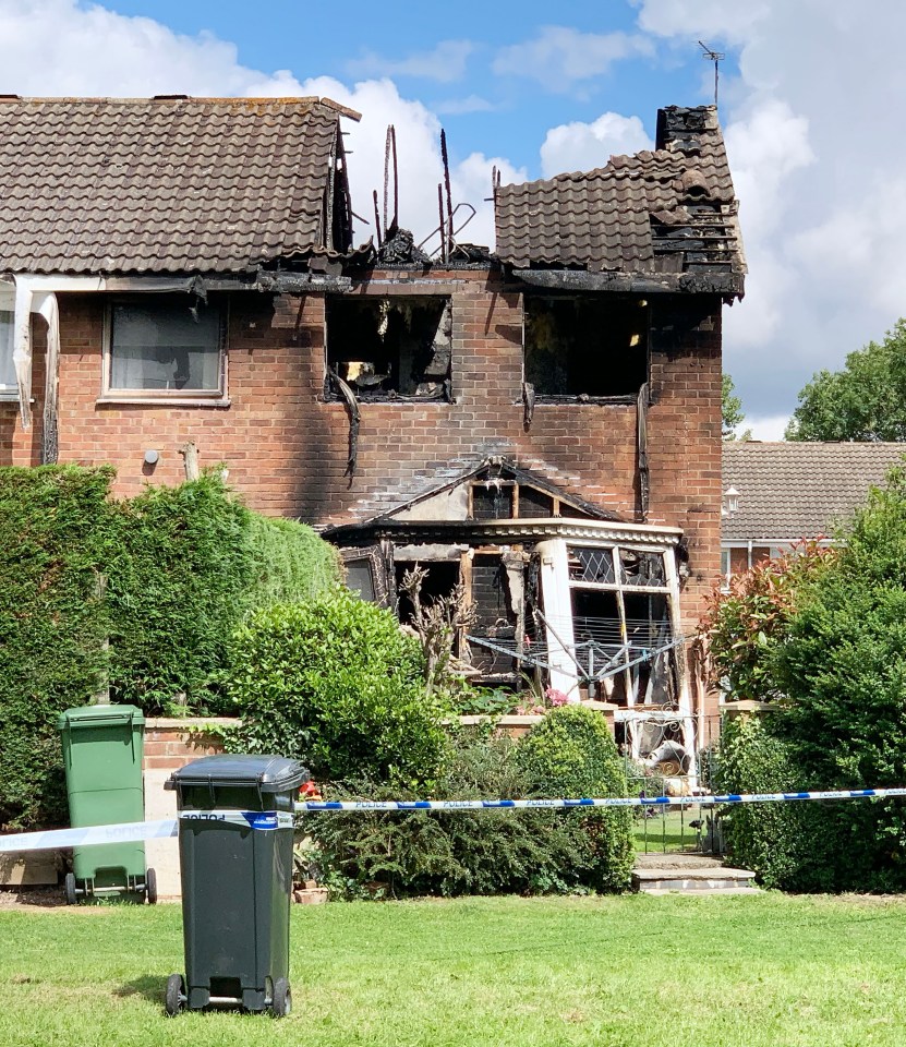 A police cordon surrounded the battered house with windows obliterated 