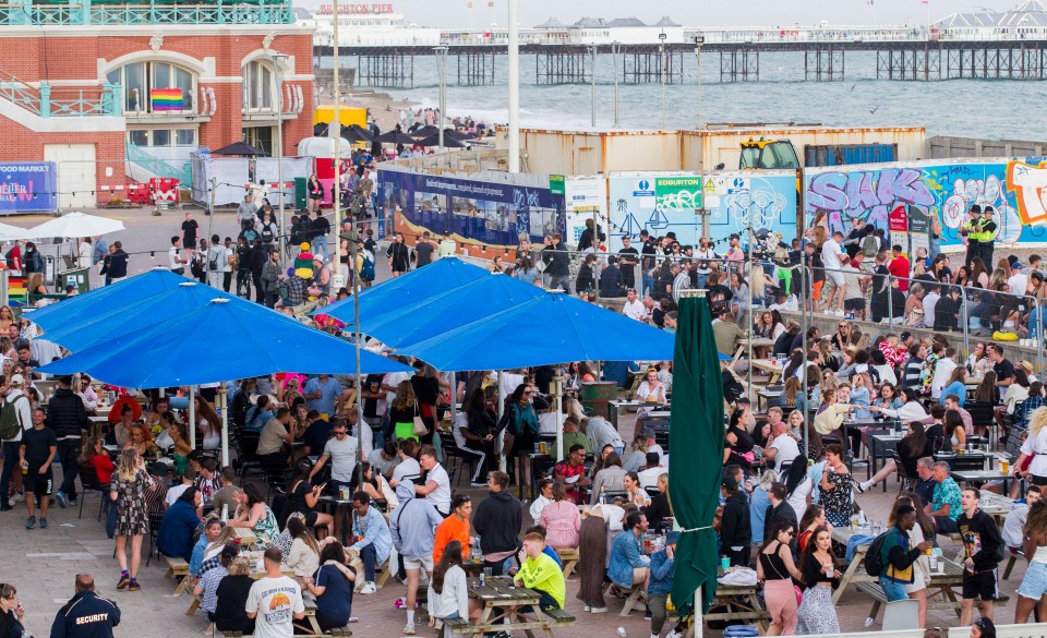 Larges crowds drink at beachside bars in Brighton