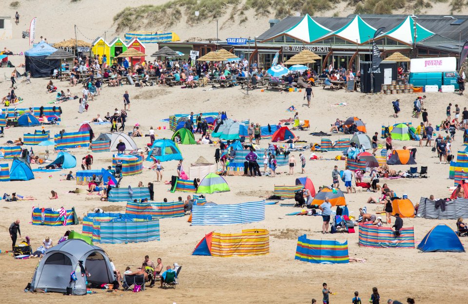 It's business as usual in Newquay, Cornwall, as Brits head for the coast for their summer holidays