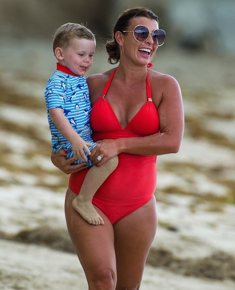 Coleen was in good spirits as she walked along the sand with son Cass