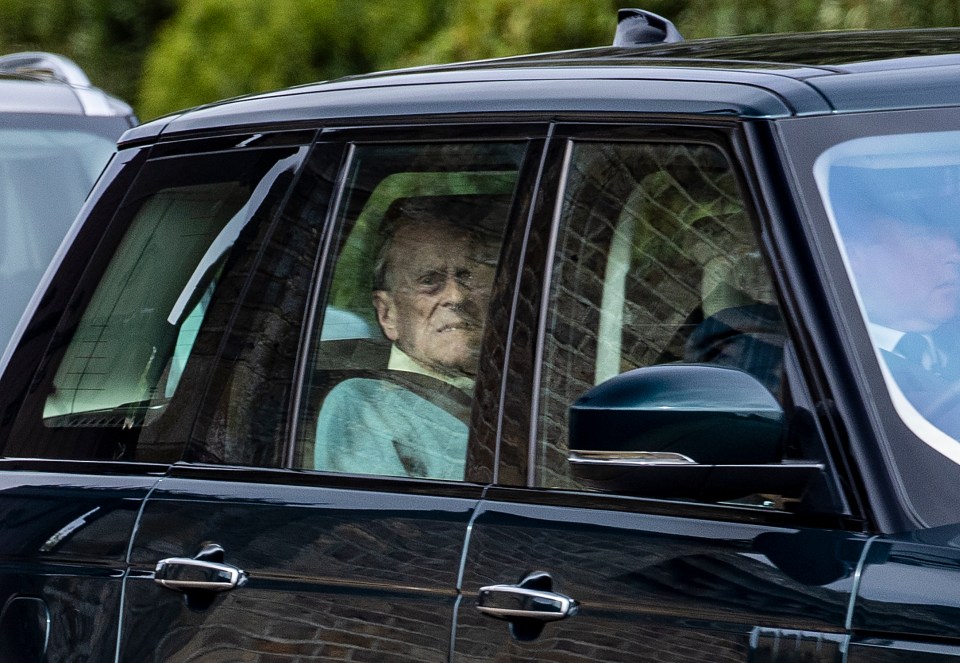 Prince Philip is seen in the car with the Queen