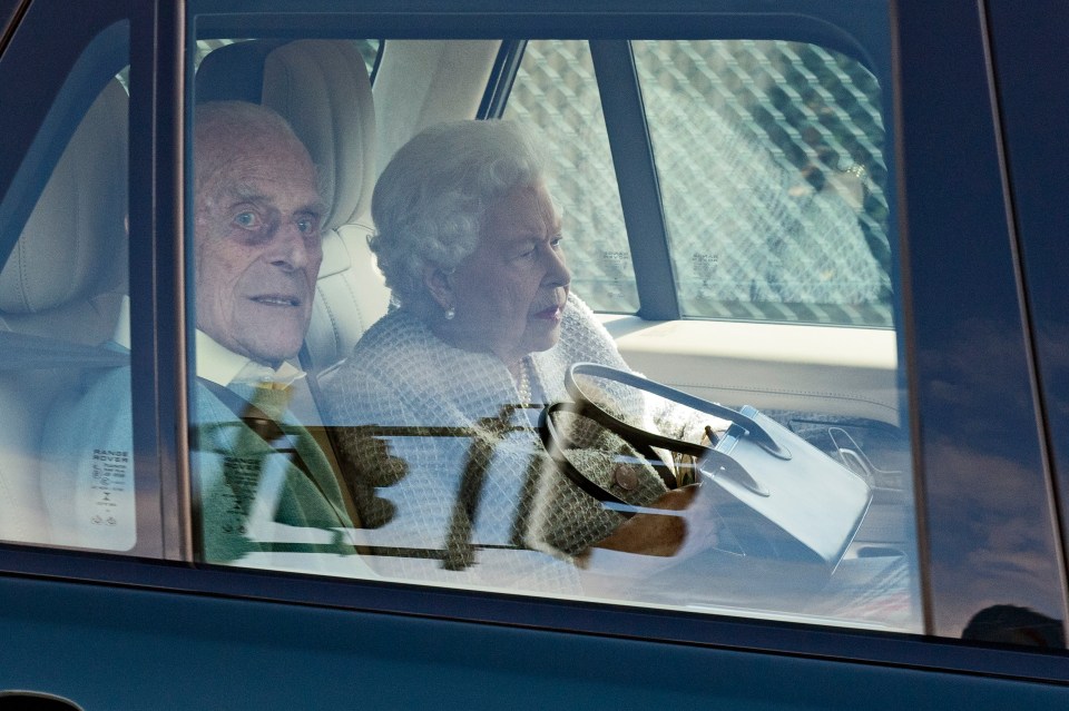 The Queen holds her handbag on her lap as she heads off from Windsor