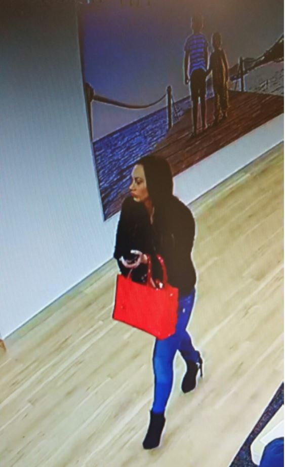 Lynsey Burdon is pictured using stolen credit card details at a TUI holiday shop in Liverpool