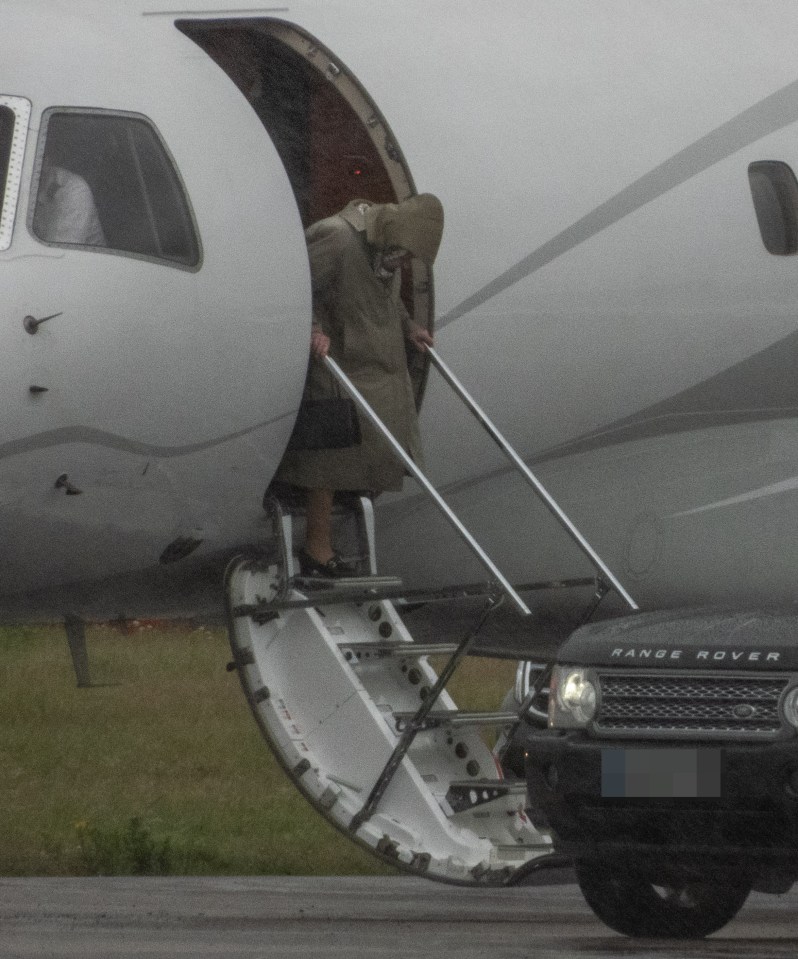 The Queen is seen stepping off the plane in Scotland