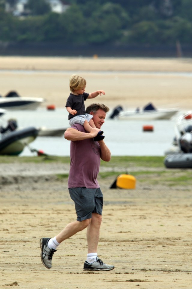 The TV chef played with his one-year-old son at the beach