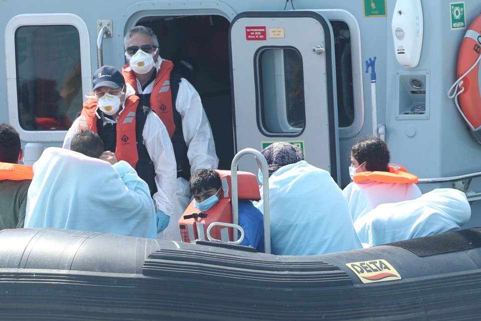 Border Force crew, pictured, bringing a group of migrants into Dover