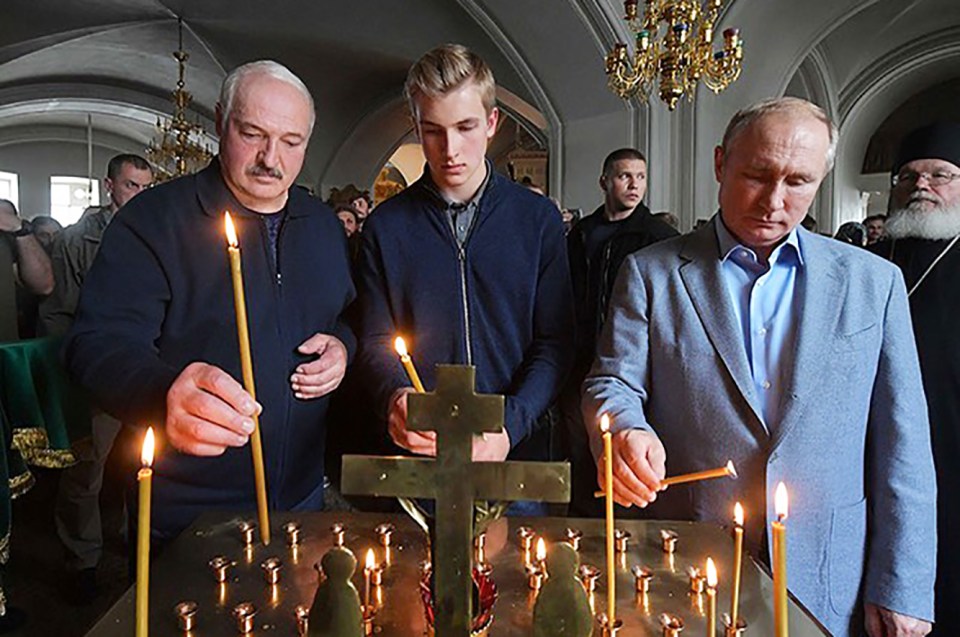 Putin lights a candle in church with his dictator pal Lukashenko