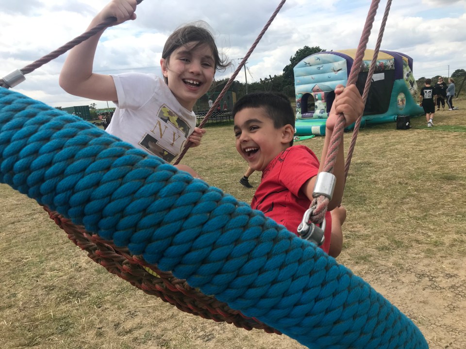 Lily, eight, and five-year-old Clark enjoy a swing