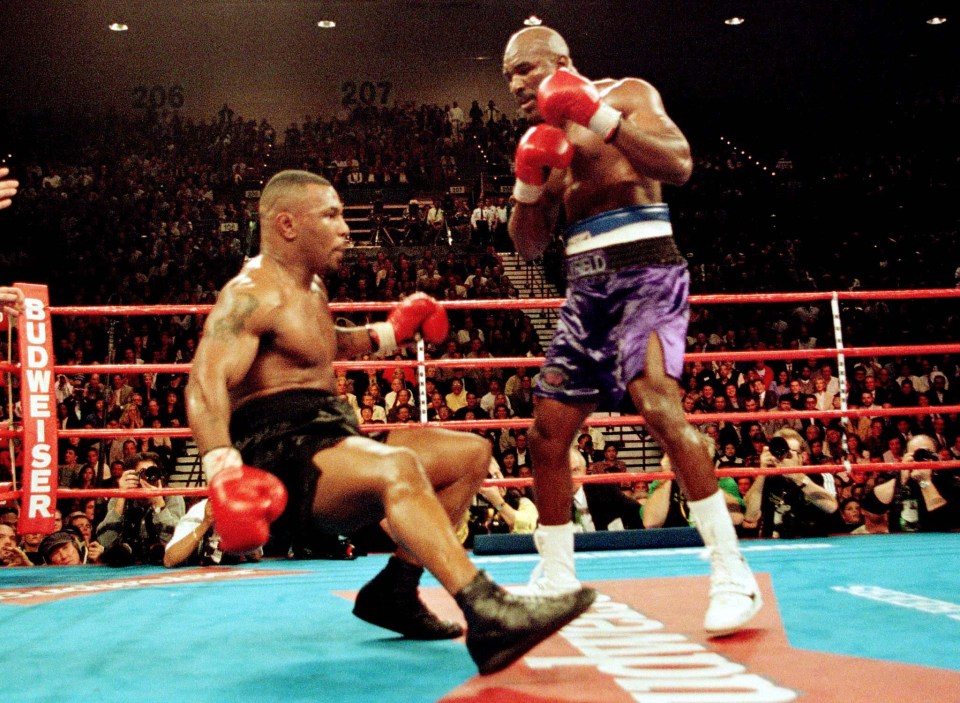 Holyfield (right) was on top of the world when he defeated Mike Tyson in 1997