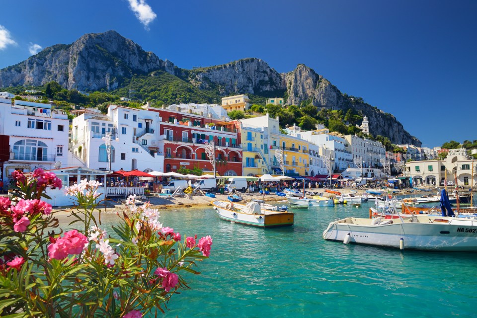 It is a 45-minute high-speed ferry to Capri from Naples - pictured is Capri's Marina Grande Harbour