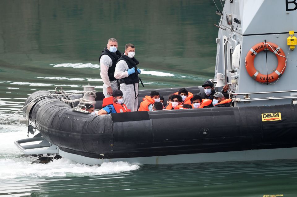 A group of people thought to be migrants are brought into Dover, Kent, by Border Force officers 