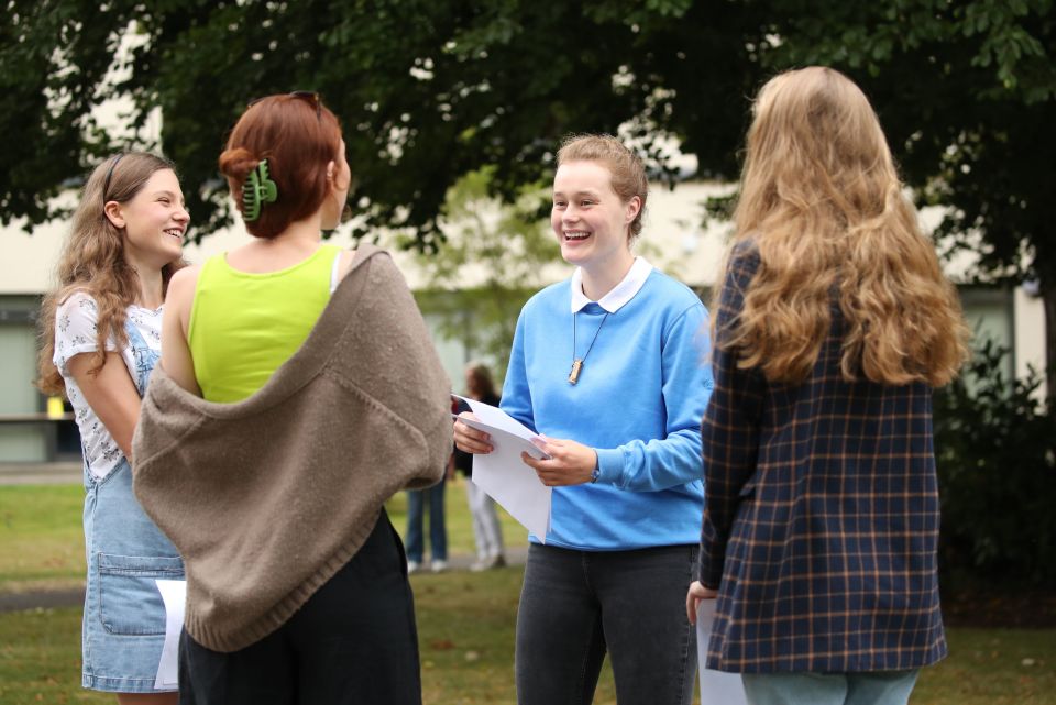 Sophie Lofthouse and Hannah Walton-Hughes grin after opening their results