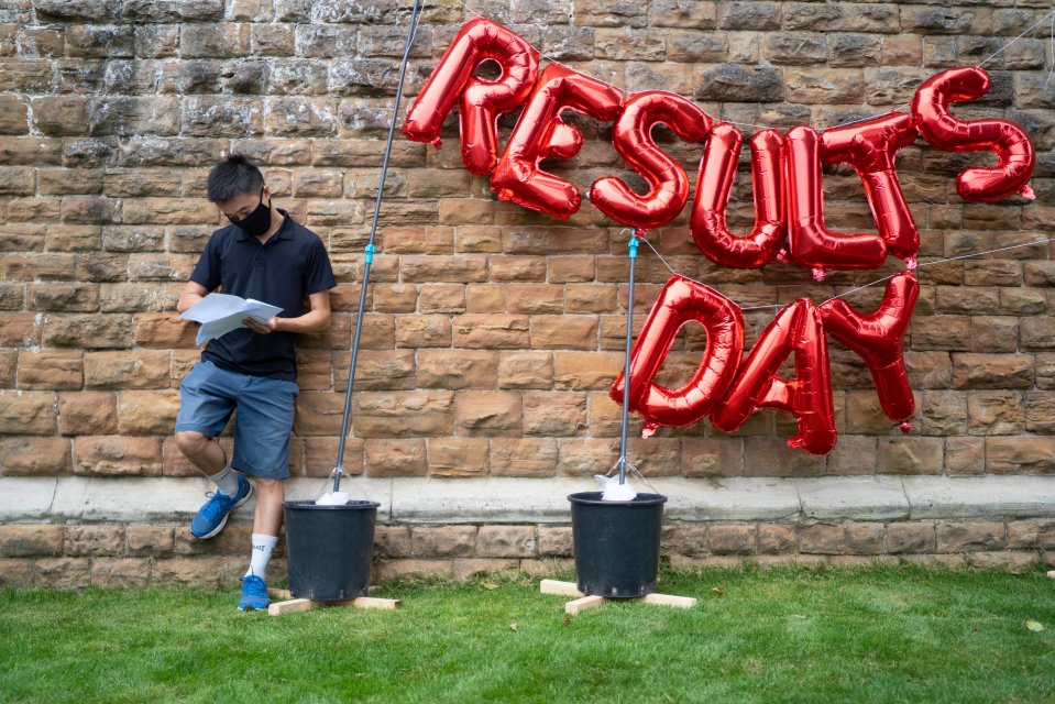 Jeffry Lu reads his results next to balloons celebrating the big day