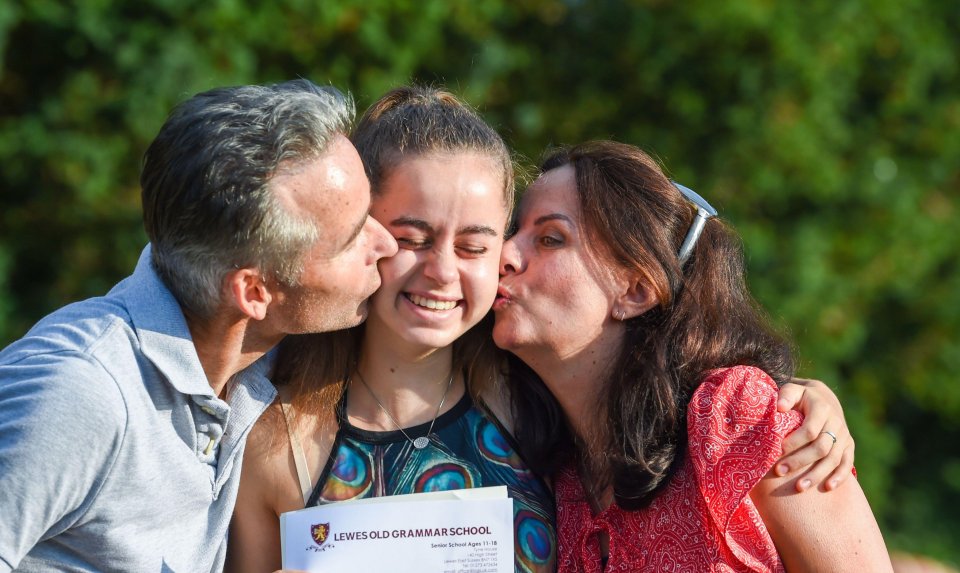 Maia Hardman grins with her parents Stephen and Maria after opening the letter with her results