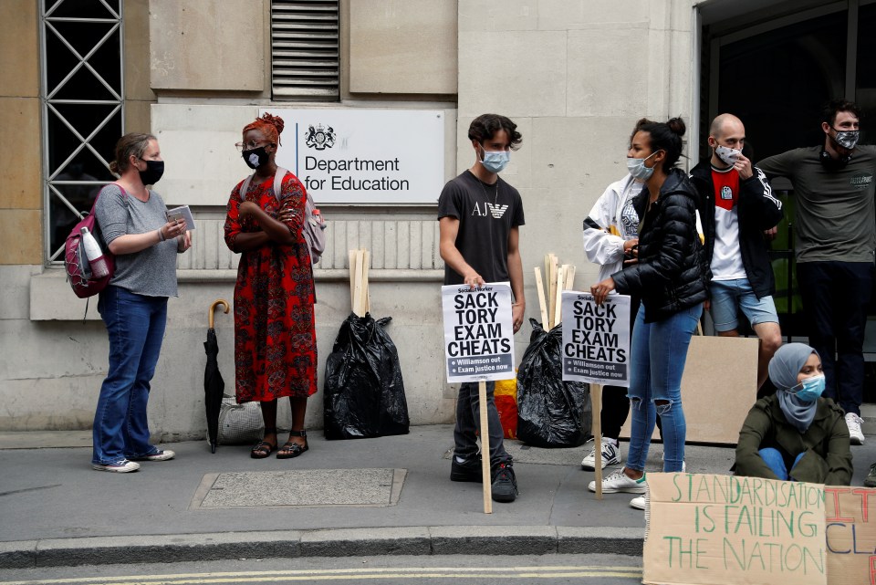 Masked students protest outside the Department of Education in London today