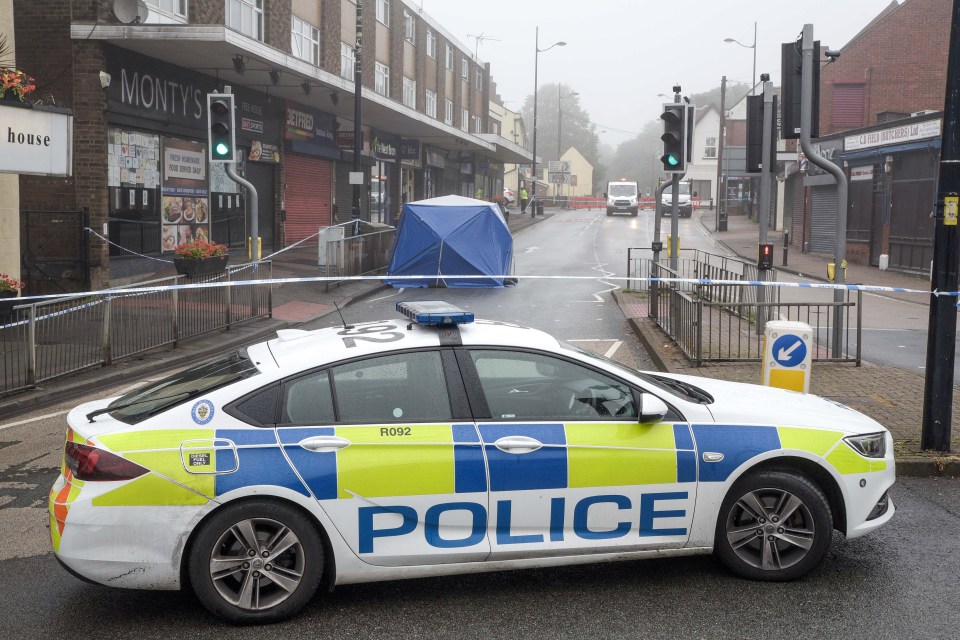 Police set up a blue forensics tent in the street