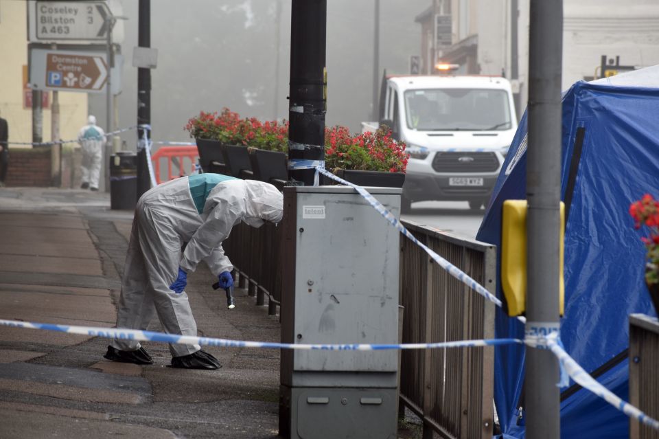 A forensics cop looks for evidence at the scene today