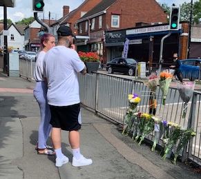 Reece's devastated girlfriend looks over tributes left for him with Reece's best friend