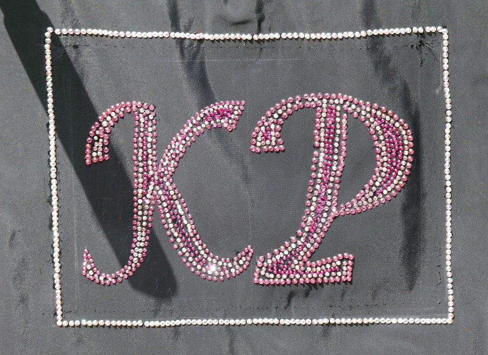 Crystals have been hand-applied to spell out Katie's initials