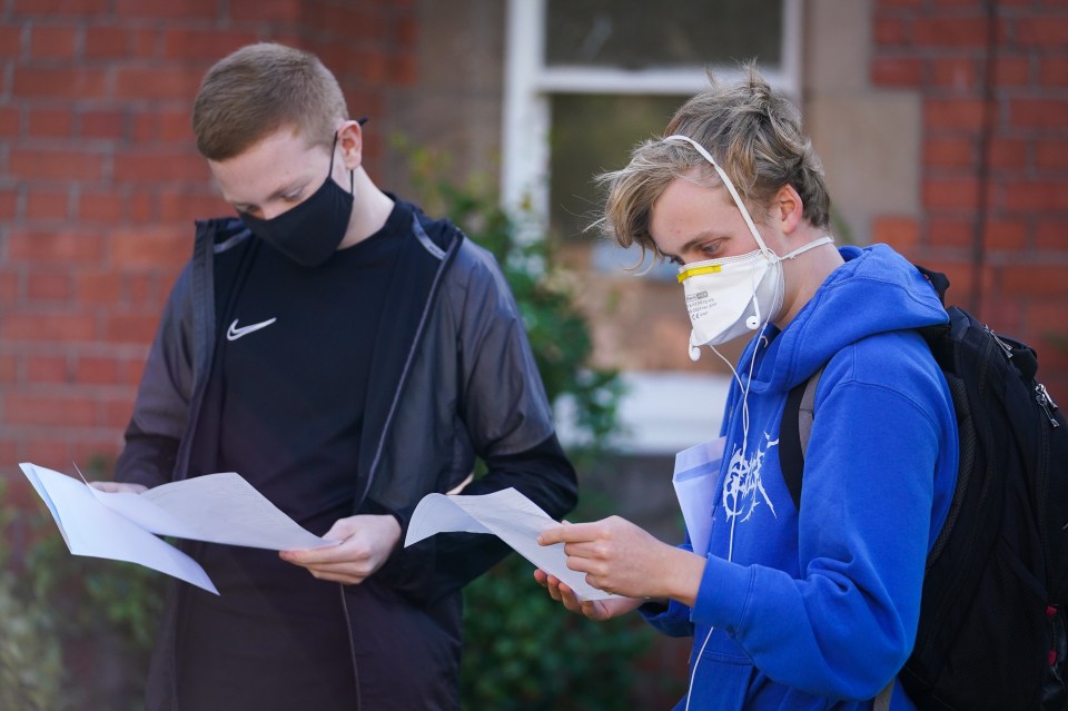 Two boys at Merchant Taylors' School in Crosby, Merseyside, wore masks as they checked their grades