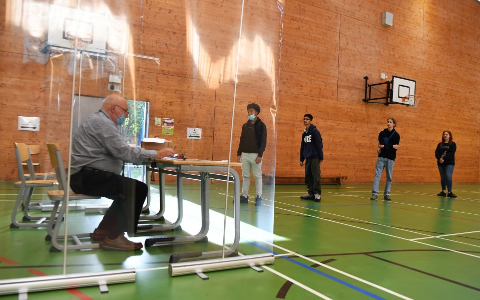 Secondary school students wait in line for their GCSE results at Kingsdale Foundation school in south London