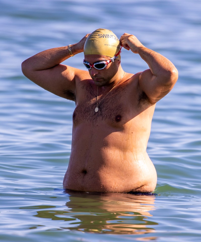 James Argent puts on a swimming cap and goggles as he enjoys a dip in the sea in Marbella